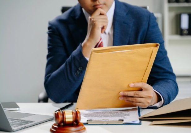 Justice and law concept.Male judge in a courtroom on white table and Counselor or Male lawyer working in office.